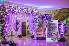 an elegant wedding setup with purple and white flowers