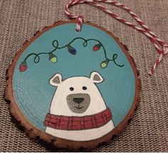 a wooden ornament with a polar bear on it