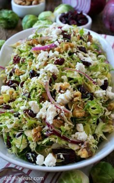 a salad in a white bowl on top of a table