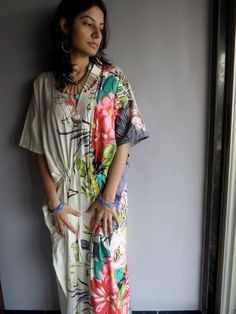 I made this Kaftan from a beautiful Cream and tons of colors 100% mulmul cotton.Mulmul is a very fine variety of cotton which is extremely soft and it gets softer with every wash.It is so free flowing, that it will make you feel as if you aren't wearing anything at all ;)The beauty of the Kaftans is they will fit everyone so no need to worry about the size et all. All my Kaftans have deep necks(11-12 inches) so will fit all head sizes.However, the length of my kaftans will vary.It is 53 inches l Multicolor Tropical Cotton Dress, Tropical Multicolor Cotton Dresses, Multicolor Relaxed Fit Maxi Dress For Summer, Multicolor Cotton Maxi Dress For Vacation, Printed Multicolor Dresses For Loungewear, Multicolor Printed Dresses For Loungewear, Long Multicolor Kaftan For Loungewear, Multicolor Floral Print Loungewear Dress, Multicolor Floral Print Dresses For Loungewear