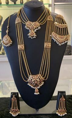 Bridal hydrabdi/punjabi style set. The set has a long necklace,a choker,matching earrings,maangtikka and jhoomar to go with it. The center pendant in sweet heart shape and comes with matching long but lightweight earrings. The earrings are jhoomar style. There are connecting Jaddau charms strung with the gold chains. The earrings can be paired with the necklace or can be worn by itself. It's a complete statement piece. Derived from the traditional jadau jewelry,it's a complete set for a bridal w Luxury Temple Jewelry Bridal Sets With Zari Work, Luxury Traditional Wear With Temple Jewelry Style, Luxury Bollywood Jewelry For Puja, Luxury Gold Temple Jewelry Traditional Wear, Luxury Temple Jewelry Danglers For Formal Occasions, Luxury Bollywood Temple Necklace With Zari Work, Luxury 22k Gold Temple Bridal Necklace, Luxury Bridal Temple Jewelry Earrings With Cutdana, Luxury Hand Set Temple Jewelry Sets