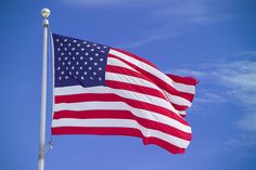 an american flag flying in the wind