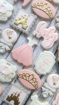 decorated cookies are arranged on a table for a princess themed baby shower or birthday party