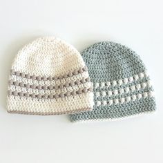 two crocheted hats sitting next to each other