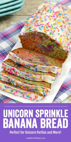 a cake with sprinkles and white frosting sitting on top of a plate