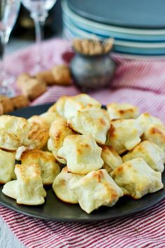 a plate filled with dumplings on top of a red and white table cloth