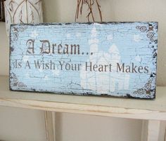 a wooden sign that says, a dream is a wish your heart makes