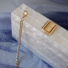 Looking for a unique and stylish piece with a designer touch? You'll love this beautiful Luxury Glossy White Acrylic Clutch Bag! With its beautiful pearlescent sheen, this stylish clutch won't go unnoticed. Perfect to dress up an outfit for a party or a wedding. Available with white or green handle, pick your favourite! Style: Eclectic Boho Chic Occasions: Evening, garden party or use as wedding bag Smart features: Hasp closure, cell phone fit, mini handle & long chain included Materials: Acryli Luxury White Chic Wallet On Chain, Luxury Chic Wallets For Parties, Luxury White Chic Wallets, Chic Luxury White Wallets, Luxury Green Mini Dress For Garden Party, Luxury Chic Wallet On Chain For Evening, Luxury Designer Wallet On Chain For Party, Luxury Chic Evening Wallet On Chain, Aesthetic Clutch