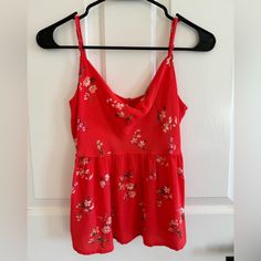 American Eagle Babydoll Tank Top Size: Xs Condition: New Without Tags, Never Worn Color: Bright Red (Almost Bright Peachy) With Floral Print Adjustable Straps Cute Red V-neck Top, Cute Red Cotton Tank Top, Cute Red Tank Top For Spring, Cute Red Spring Tank Top, Cute Red Summer Tank Top, Cute Red Sleeveless Top, Fitted Red Floral Print Tank Top, Red Cotton Camisole Top, Casual Red Camisole For Spring