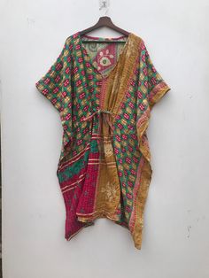 A vintage Kantha kaftan sounds like a beautiful fusion of cultural heritage and fashion. Kantha is a traditional embroidery technique from the Indian subcontinent, particularly prevalent in West Bengal and Bangladesh, where layers of old saris and dhotis are stitched together to create new textiles. Kaftans, on the other hand, have a long history in various cultures, often associated with loose, flowing garments worn in many parts of the world. Combining the two, a vintage Kantha kaftan would li Multicolor Ikat Print Kaftan For Festive Occasions, Multicolor Ikat Print Kaftan Tunic, Festive Multicolor Block Print Kaftan, Multicolor Bohemian Kurta With Ikat Print, Bohemian Multicolor Ikat Print Kurta, Traditional Bandhani Print Kaftan For Festivals, Green Bohemian Kaftan For Festive Occasions, Bohemian Green Festive Tunic, Green Bohemian Tunic For Festive Occasions