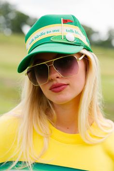 Add some personality to your golf game with our Talk Birdie To Me trucker hat. The green color and yellow/white striped ribbon are a fun twist on a classic look, and the 18th hole golf patch adds a touch of charm. Let your hat do the talking on the course! All orders are currently shipping within 14 business days. To receive item quicker, expedited shipping is available at checkout. Retro Green Visor Baseball Cap, Green Golf Cap, Green Baseball Cap For Golf, Adjustable Green Hat For Golf, Adjustable Green Golf Hat, Green Trucker Hat, Girls Golf, Striped Ribbon, Golf Hats