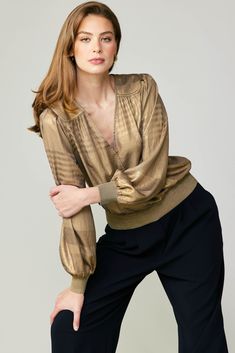 This is the perfect party top thanks to its plunging surplice neckline and subtly striped metallic shimmer. Featuring a gently crinkled texture, the long-sleeve style has a relaxed fit, paneled shoulders, and glittery rib trim. •Surplice neckline •Paneled shoulders •Long sleeves •Relaxed fit •Glitter rib trim at cuffs & hem item number 2230090-1 100% Polyester Gold V-neck Blouse For Work, Gold V-neck Top For Fall, Chic V-neck Long Sleeve Top For Night Out, Evening V-neck Top With Blouson Sleeves, Chic Shimmer Top For Fall, Chic Shimmer Tops For Fall, Metallic Long Sleeve Glamorous Blouse, Metallic Long Sleeve Tops For Work, Metallic Long Sleeve Tops For Fall