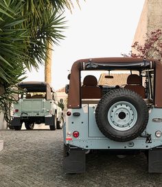 two jeeps are parked next to each other