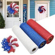 patriotic decorations are displayed in front of a blue house with red, white and blue decor