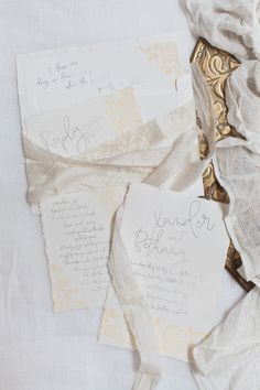 the wedding stationery is laid out on top of each other