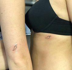 two women with matching tattoos on their stomachs