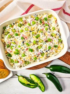 a casserole dish with peas, cheese and crackers