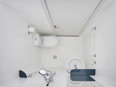 a bathroom with white walls and blue carpeted flooring is shown in this image