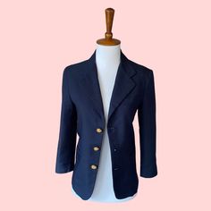 Originally part of a boy's school uniform, this navy blue blazer features gold buttons and a unique "shrunken" silhouette which looks as classic as it does cool. Bust 38in Shoulder 15in Sleeve 17.5in Length 21in Navy Business Blazer With Button Closure, Business Blazer With Gold Buttons, Long Sleeve, Tailored Navy Peacoat With Buttons, Navy Blazer With Button Closure And Suit Collar, Navy Blazer With Suit Collar And Button Closure, Navy Double-breasted Blazer With Buttons, Navy Notch Lapel Peacoat With Buttons, Classic Navy Sport Coat With Button Closure, Navy Peacoat With Buttons For Formal Occasions