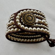 Glass pearl beads are hand woven onto genuine, natural dye brown leather 3mm cord to create this statement cuff bracelet. Closure is a bronze button with circular design.  Size: 1 3/4" wide 8" end to end 6" to 7" wrist is ready to ship If you need a smaller or larger size, please indicate wrist size in comments and I will make to order - will add 3-5 days to processing time. All of my limited edition designs are curated for anyone seeking unique and custom jewelry. My PROMISE to you: I am incredibly thankful to you for choosing my designs. Each piece is inspired and mindfully crafted by me - in my studio or on the road during an adventure - so no two pieces are identical and small variations and imperfections in shape, size, and color may occur due to the nature of natural materials.  Cust Statement Cuff Bracelet, Chic Bracelet, Beaded Cuff Bracelet, Circular Design, Beaded Cuff, Bride Gift, Jewelry Boho, Boho Bride, Natural Dye