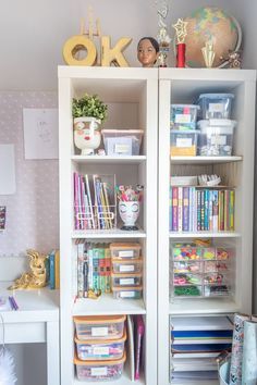 a white bookcase filled with lots of books