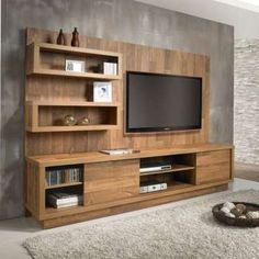 a wooden entertainment center with a flat screen tv mounted on it's side wall