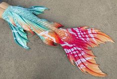 there is a fish made out of paper on the ground with words that read, with all fins