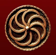 an image of a circular object in the shape of a spiral on a red background