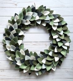 a wreath made out of green and white paper