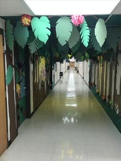 the hallway is decorated with paper leaves and flowers on it's sides, along with other decorations