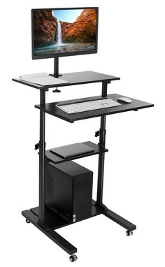 a computer desk with a monitor and keyboard on it