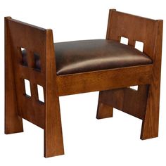 a wooden chair with leather seat and back rest