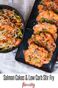 salmon cakes and low carb stir fry on a black platter next to a bowl of noodles