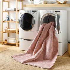 a washer and dryer sitting next to each other in a room