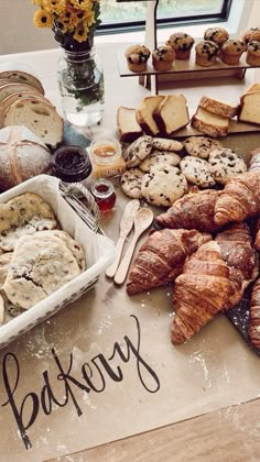 a table topped with lots of pastries and bread