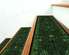 the carpet is green and black with intricate designs on it, along with wooden steps