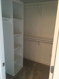 an empty closet is shown with white shelves