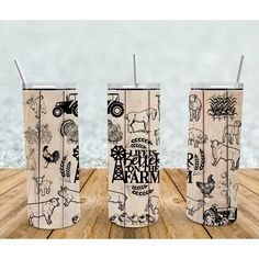 three tumblers with farm animals on them sitting on a wooden table