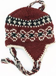 This is a pure wool hand-knit hat - in rust red, black, white - with ear flaps and top and side tassels. This winter/ski hat has a fleece lining and One size fits most but can be snug on a large head. The hat is designed for the outdoors, for the cold and windy conditions, including your ski trips. Or just wear it anytime to stay warm and cozy. Red Wool Winter Hat, Burgundy Brimmed Winter Hat, Hand Knitted Winter Hats With Ear Flaps, Winter Hand Knitted Hats With Ear Flaps, Traditional Beanie Hats For Winter, Traditional Beanie For Winter, Winter Crochet Hat With Ear Flaps, Traditional Brown Winter Hat, Retro Winter Hat