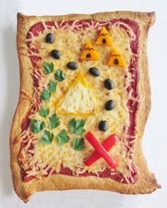 a piece of art made to look like a pizza with toppings and eyes on it