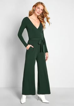 Highlight your propensity for polish with this dark green jumpsuit from our ModCloth namesake label! Crafted from a stretch-infused crepe fabric, and detailed with long sleeves on either side of the surplice neckline, a sleek waist sash, and essential pockets, this wide-leg one piece is a surefire stunner for casual outings and swanky occasions alike.
95% Polyester, 5% Spandex. 
Machine wash. 
Side pockets. Removable sash.
Made in the United States
Model is wearing size:
1X  S 
Fabric provides s Chic Green Long Sleeve Jumpsuits And Rompers, Chic Green Jumpsuits And Rompers For Fall, Solid Belted Jumpsuits And Rompers For Fall, Fall Solid Color Belted Jumpsuits And Rompers, Formal Jumpsuits And Rompers For Fall, Green Tie Waist Jumpsuit For Work, Tie Waist Long Sleeve Jumpsuits And Rompers, Solid Color Long Sleeve Jumpsuit With Tie Waist, Long Sleeve Solid Jumpsuit With Tie Waist