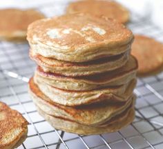 a stack of pancakes sitting on top of a cooling rack next to each other,