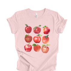 Calling all Apple Lovers! You'll be cute and comfy this fall from the orchard to the oven in your Cottagecore Botanical Apple T-shirt. Exclusively designed by Parcel 23 and printed in the USA Select the size you need, proceed to checkout, and we'll have it produced and delivered in about a week. This print is direct-to-garment printed, not a transfer. We've selected everybody's favorite, Bella + Canvas unisex jersey tee for this design. If you don't already own one of these shirts, you'll love it. Sustainably sourced, 100% cotton (heather and vintage colors are cotton/poly blend) Medium weight fabric. Unisex T-shirt Fit.  If you like it fitted, size down. Anything we can do for you, contact Jami via Etsy Messages. BIG THANKS for shopping small. Parcel23.etsy.com Fruit Shirt, Apple Orchard, Fall Apples, Vintage Botanical, Vintage Colors, Gift For Lover, Graphic Tees, Adult Outfits, Fruit