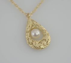 "Filigree necklace - this necklace is adorned with a 14K gold filigree teardrop pendant. A pearl accents the center of the pendant. One side of the pendant is detailed and the other is smooth. Can be worn both ways. Simply stunning. The necklace will be shipped in a beautiful gift box. ★ Filigree teardrop is 14k solid gold, it is 3/4\" x 1/2\". ★ 5 x 6.7mm freshwater cultured pearl ★ The necklace is 14K yellow gold . Please choose 1.5mm flat cable chain (delicate ) or 1.3mm Double rope chain. Pl 14k Gold Teardrop Pearl Pendant, Elegant Engraved Drop Jewelry, Formal Gold Pear-shaped Drop Necklace, Gold Pear-shaped Drop Necklace For Formal Occasions, Gold Pear-shaped Drop Necklace For Formal Events, Pear-shaped Gold Drop Necklace For Formal Occasions, Wedding Filigree Teardrop Necklace, Teardrop Pearl Pendant In Yellow Gold, Anniversary Teardrop Pearl Pendant Drop Necklace