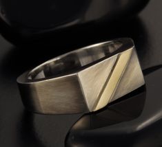 Mens Signet Ring, This piece is packed in a beautiful jewelry box, and is ready to be given as a meaningful gift. Features: ◆ Sizes: 4-16(US) ◆ Width: 8.9 mm. ◆Height from finger 3.5 mm at the top. ◆ Made of Sterling silver & 14K Gold . Please note, the ring is handmade, the coating levels and texture marks can vary from one ring to the next. ◆Engraving - I'd be happy to add a personal engraving. To make your unique ring even more special, please add the following item to your cart: www.etsy Rectangular Tension Setting Ring As A Gift, Modernist Signet Ring With Polished Finish For Anniversary, Modern Diamond Cut Signet Ring As Gift, Modern Diamond Cut Signet Ring Gift, Modernist Polished Signet Ring As Gift, Modernist Polished Finish Signet Ring As Gift, Modern Hallmarked Engraved Ring For Formal Occasions, Modernist Hallmarked Signet Ring For Gift, Modernist Hallmarked Signet Ring As Gift