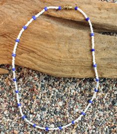 White with Blue accents Glass Beaded Necklace 15" 15 inches in length with a gold metal screw clasp. Hand crafted in the USA Made in a smoke free and pet free environment. Blue Single Strand Heishi Bead Necklaces, Blue Beaded Necklaces With Large Heishi Beads, Blue Single Strand Heishi Beaded Necklaces, Blue Single Strand Heishi Beads Necklace, Blue Single Strand Heishi Beaded Necklace, Cary Nc, Oct 30, Glass Bead Necklace, Blue Accents