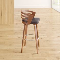 a wooden bar stool with black leather seat and backrest in an empty living room