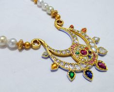 Vintage antique 23 K solid gold and natural Navratna gemstones set large pendant strung together with pearls and gold beads. Great one of type collection piece in very good condition. Length-Free size, Size of pendant-10/9 cm, gross weight-137 grams, pendant weight only-76 grams, Material-23 K gold, Natural uncut Diamonds, and Natural Navratna gemstones. Traditional 22k Gold Multi-stone Necklaces, Traditional Multi-stone 22k Gold Necklace, Spiritual Kundan Gemstone Necklace, Gold Kundan Necklace With Gemstones For Spiritual Use, Gold Kundan Necklace With Gemstone For Spiritual Occasions, Gold Kundan Necklace With Gemstone For Spiritual Events, Spiritual Gold Kundan Necklace With Gemstones, Gold Kundan Multi-stone Temple Necklace, Gold Multi-stone Kundan Temple Necklace