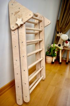 a wooden toy ladder with stars on it