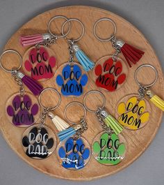 a bunch of key chains that have different designs on them with the words dog mom